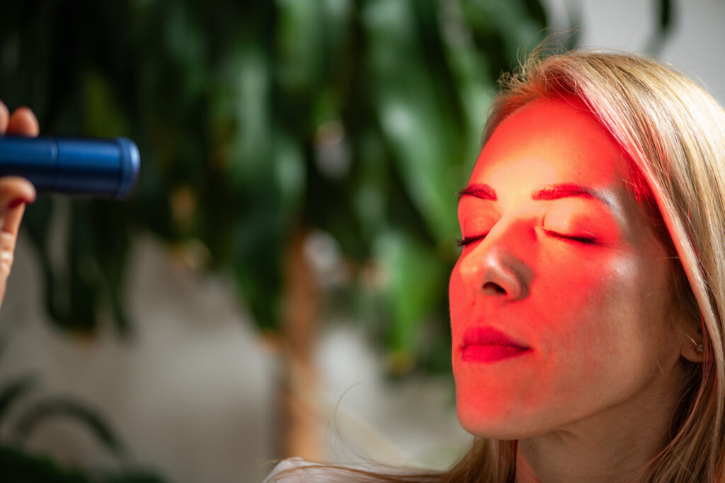 Woman tries red light therapy for eyes.