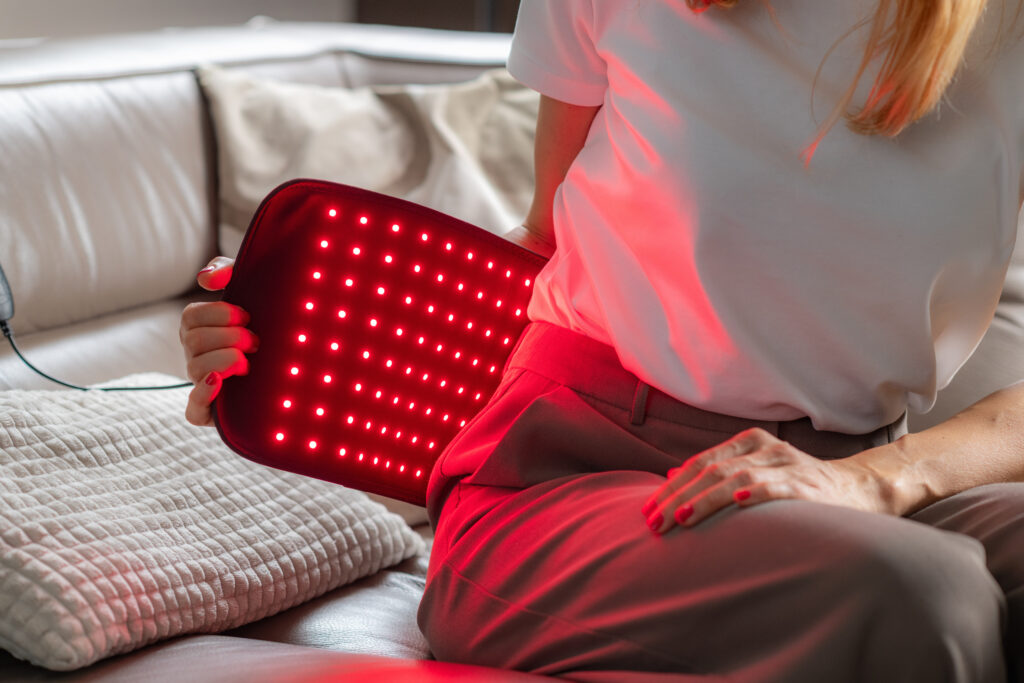 Woman using red light therapy for weight loss.